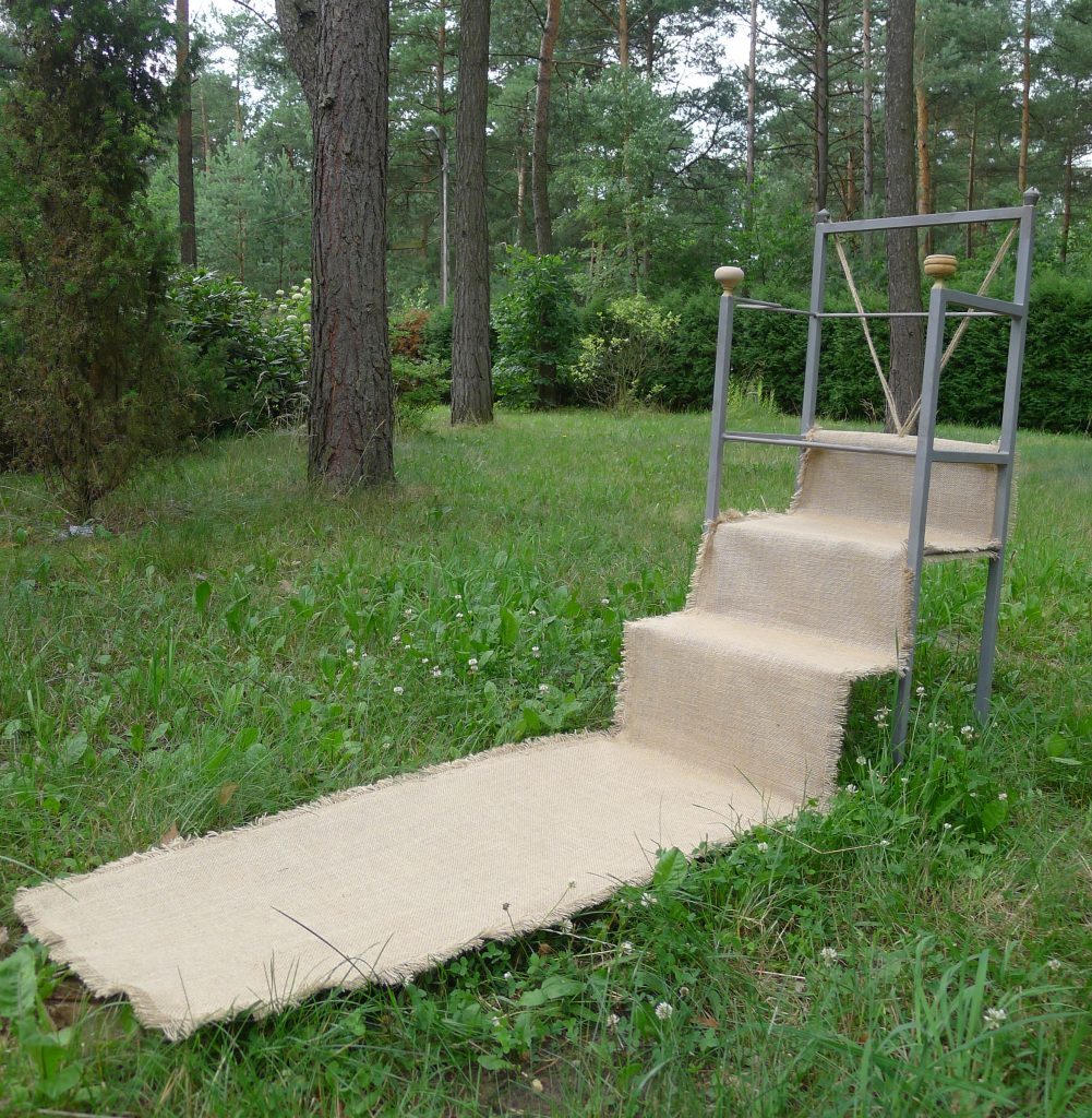 Spatial object titled In Homage to Magdalena Abakanowicz from 2015, dimensions 55x180x105 cm, made of sandblasted steel, wood, and jute, by Danuta Krajewska-Pietrasik.